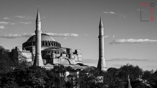 There's really nothing wrong with <a href="https://www.flickr.com/photos/wrherndon/6980950752/in/album-72177720315376572/">my color shot of the Ayasofya posted in 2012</a>. The light was excellent and the vantage point couldn't have been better. Really...nothing marred the picture other than the rather 'noisy' sky--what you get when shooting a 4/3 camera in 2012. (And, perhaps, my somewhat clumsy composition.) But I think this B&W, which benefits from modern noise reduction, my considerably improved monochrome editing skills, and a better eye for the vertical balance...is superior.